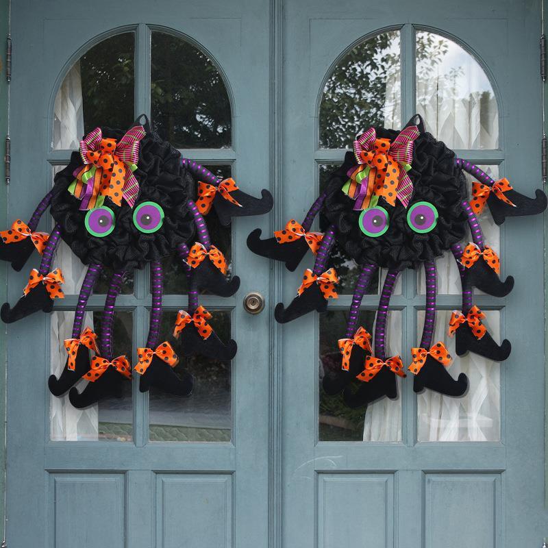 Multi-legged spider wreath hanging on a front door – Halloween spider web decoration