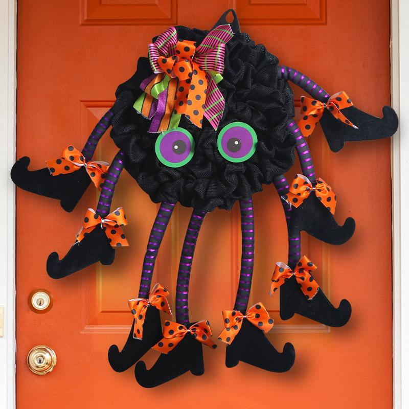 Multi-legged spider wreath hanging on a front door – Halloween spider web decoration