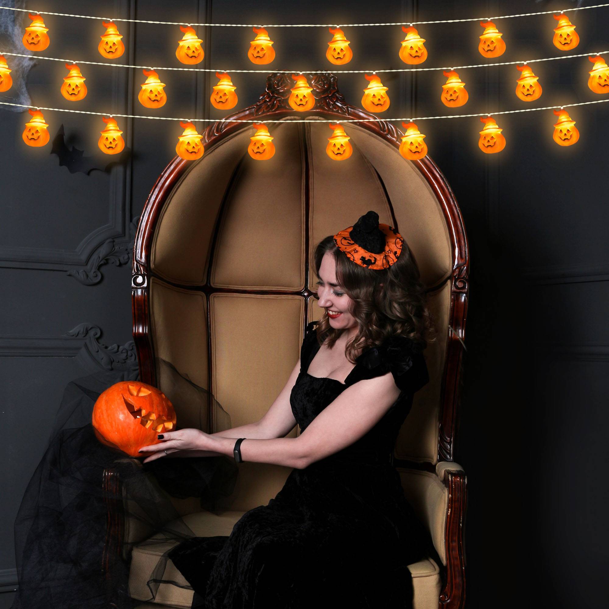 Close-up of battery-powered Halloween string lights with ghost and pumpkin shapes