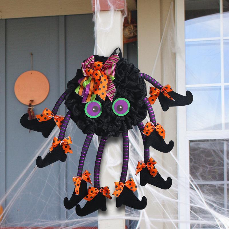 Multi-legged spider wreath hanging on a front door – Halloween spider web decoration