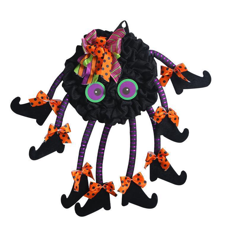 Multi-legged spider wreath hanging on a front door – Halloween spider web decoration