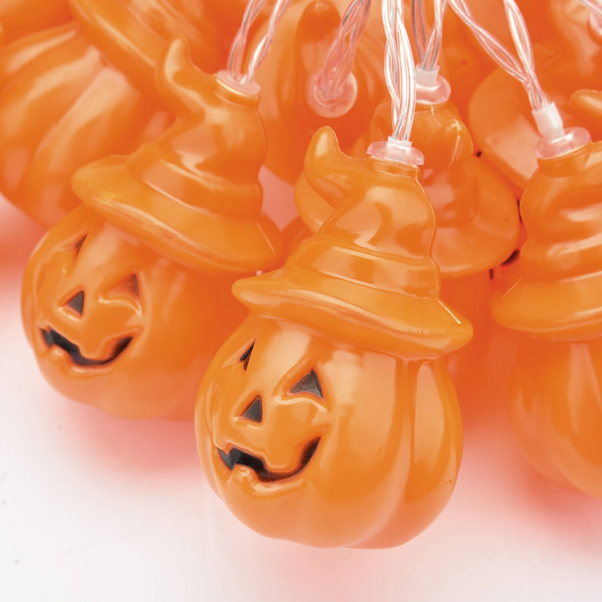 Close-up of battery-powered Halloween string lights with ghost and pumpkin shapes